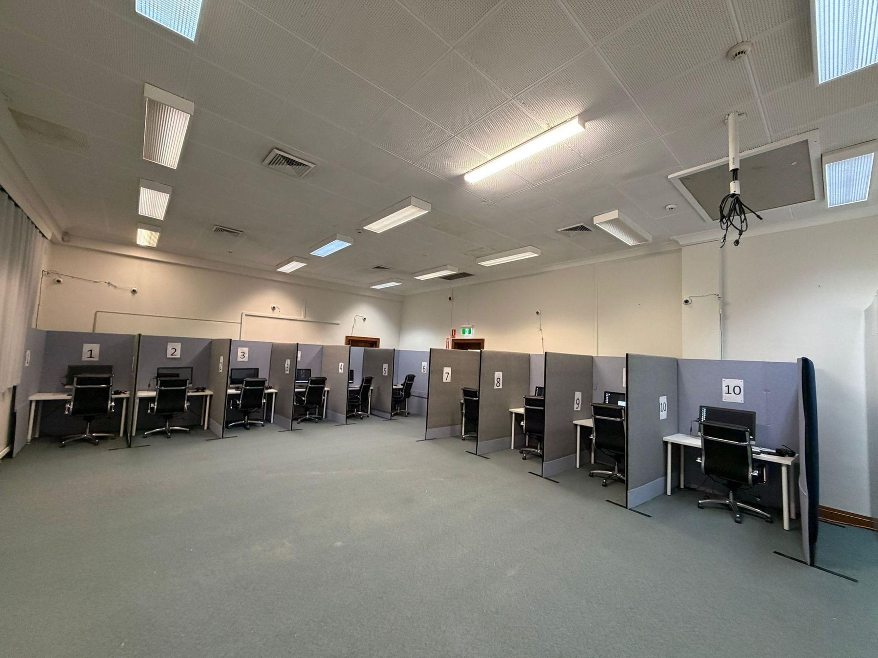Numbered testing workstations inside the Newcastle test centre